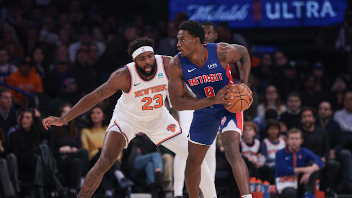 Nov 30, 2023; New York, New York, USA; New York Knicks guard Donte DiVincenzo (0) shields the ball from New York Knicks center Mitchell Robinson (23) during the first half at Madison Square Garden. Mandatory Credit: Vincent Carchietta-Imagn Images