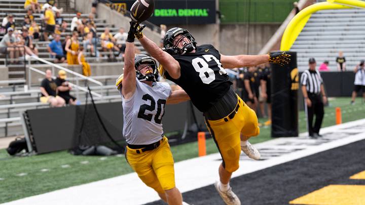 Iowa defensive back Ty Hudkins (20) and Iowa tight end Addison Ostrenga (87) reach for the football Aug. 15, 2026 during the Kids Day at Kinnick open practice at Kinnick Stadium in Iowa City, Iowa. The pass landed incomplete. Iowa defensive back Ty Hudkins (20) and Iowa tight end Addison Ostrenga (87) reach for the football Aug. 15, 2026 during the Kids Day at Kinnick open practice at Kinnick Stadium in Iowa City, Iowa. The pass landed incomplete.