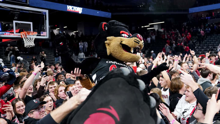 The Cincinnati Bearcats mascot crowd surfs after the students rushed the court at the conclusion of a college basketball game between the TCU Horned Frogs and the Cincinnati Bearcats, Tuesday, Jan. 16, 2024, at Fifth Third Arena in Cincinnati. The Cincinnati Bearcats won, 81-77.