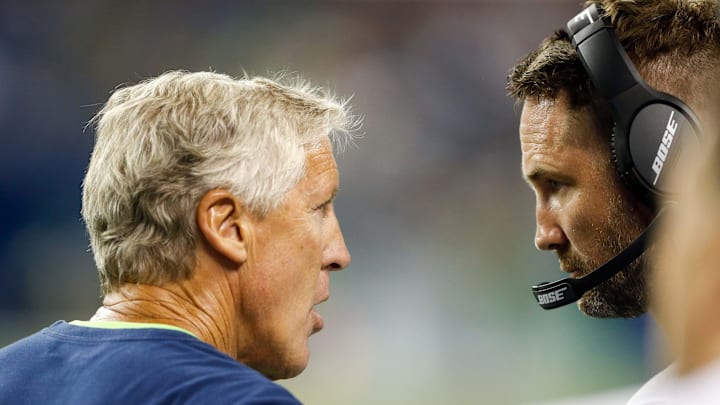Seattle Seahawks head coach Pete Carroll, left, talks with offensive coordinator Brian Schottenheimer
