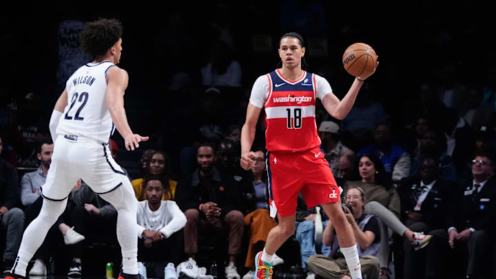 Oct 14, 2024; Brooklyn, New York, USA; Washington Wizards forward Kyshawn George (18) looks to pass the ball against Brooklyn Nets forward Jalen Wilson (22) during the first half at Barclays Center. Mandatory Credit: Gregory Fisher-Imagn Images