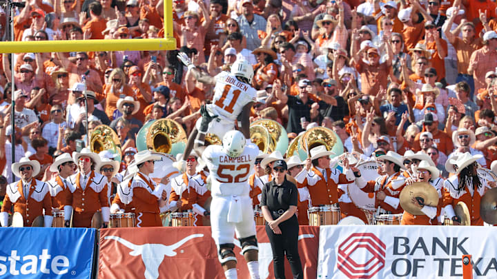 Oct 12, 2024; Dallas, Texas, USA;  Texas Longhorns wide receiver Silas Bolden (11) celebrates a touchdown with Texas Longhorns offensive lineman DJ Campbell (52) during the first half against the Oklahoma Sooners at the Cotton Bowl. Mandatory Credit: Kevin Jairaj-Imagn Images