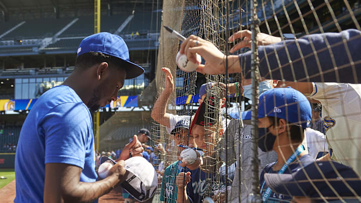 Seattle Mariners pitcher Justin Dunn (35) signs autographs before a game against the Kansas City Royals at T-Mobile Park in 2021.