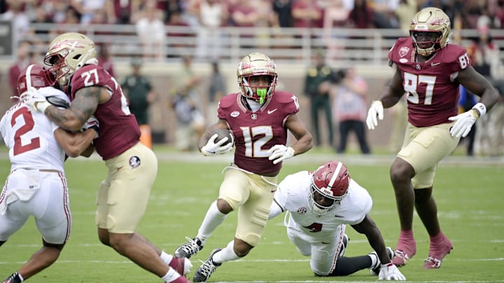 Aug 30, 2025; Tallahassee, Florida, USA; Florida State Seminoles running back Jaylin Lucas (12) runs with the ball against the Alabama Crimson Tide during the first half at Doak S. Campbell Stadium. Mandatory Credit: Melina Myers-Imagn Images