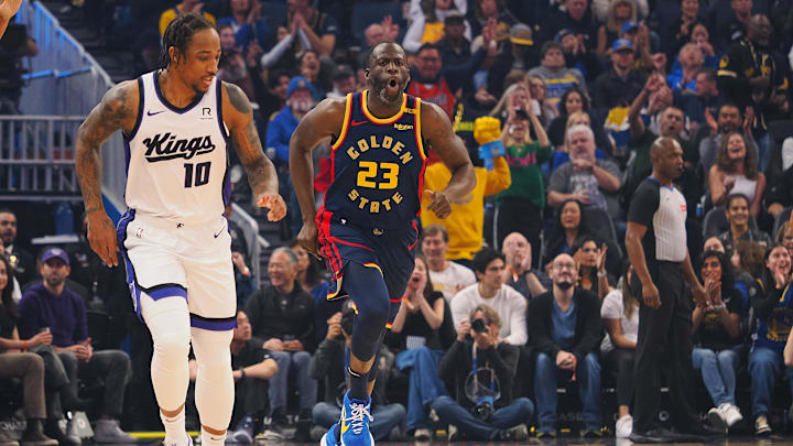 Jan 5, 2025; San Francisco, California, USA; Golden State Warriors forward Draymond Green (23) reacts after scoring a basket against tSacramento Kings forward/guard DeMar DeRozan (10) during the first quarter at Chase Center. Mandatory Credit: Kelley L Cox-Imagn Images