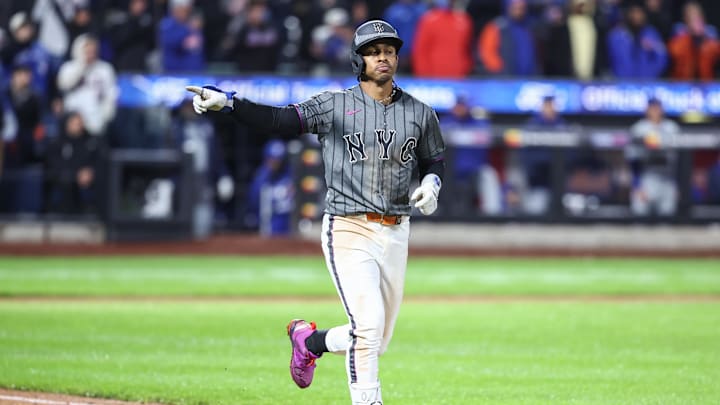 Apr 5, 2025; New York City, New York, USA;  New York Mets shortstop Francisco Lindor (12) hits a game winning sacrifice fly in the ninth inning against the Toronto Blue Jays at Citi Field. Mandatory Credit: Wendell Cruz-Imagn Images