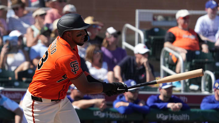 Feb 27, 2026; Scottsdale, Arizona, USA; San Francisco Giants right fielder Victor Bericoto (83) hits an RBI ground out against the Los Angeles Dodgers in the second inning at Scottsdale Stadium. Mandatory Credit: Rick Scuteri-Imagn Images