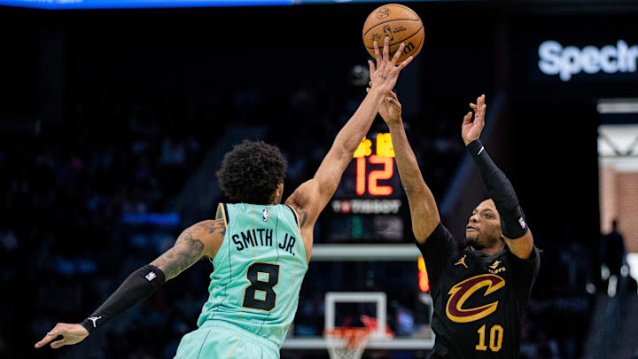 Dec 7, 2024; Charlotte, North Carolina, USA; Charlotte Hornets guard Nick Smith Jr. (8) blocks the shot from Cleveland Cavaliers guard Darius Garland (10) during the fourth quarter at Spectrum Center. Mandatory Credit: Scott Kinser-Imagn Images