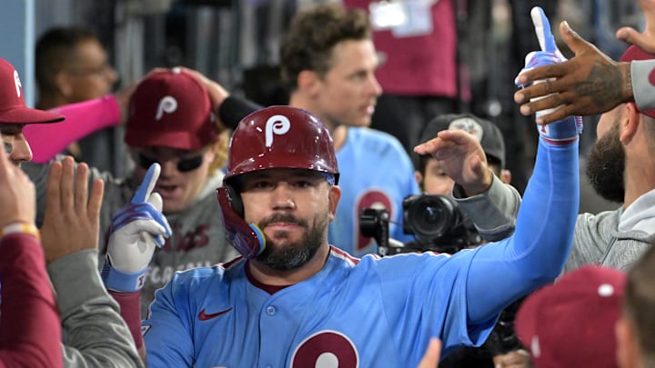 Oct 8, 2025; Los Angeles, California, USA; Philadelphia Phillies designated hitter Kyle Schwarber (12) congratulated in the dugout after hitting a solo home run in the fourth inning against the Los Angeles Dodgers of game three of the NLDS during the 2025 MLB playoffs at Dodger Stadium. Mandatory Credit: Jayne Kamin-Oncea-Imagn Images