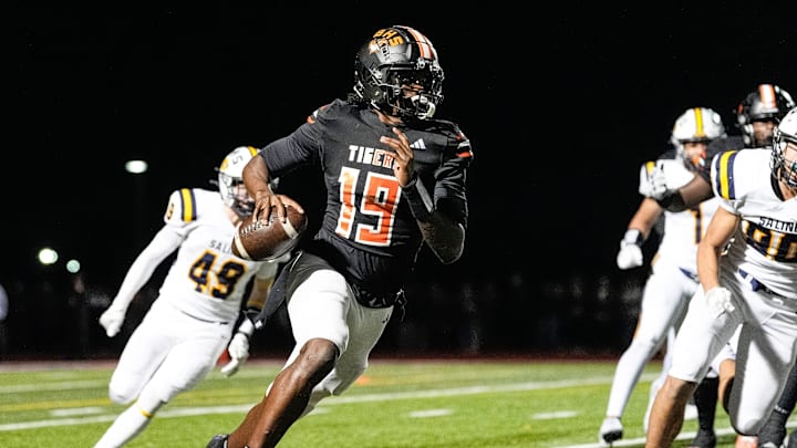 Belleville quarterback Bryce Underwood keeps the ball and runs against Saline during the second half of district final at Belleville High School in Belleville on Friday, Nov. 8, 2024.