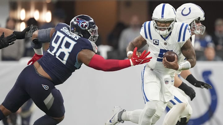 Dec 22, 2024; Indianapolis, Indiana, USA; Indianapolis Colts quarterback Anthony Richardson (5) works to rush past Tennessee Titans defensive tackle Jeffery Simmons (98) during a game against the Tennessee Titans at Lucas Oil Stadium. Mandatory Credit: Grace Hollars/USA Today Network via Imagn Images 