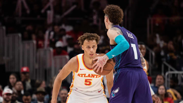 Oct 25, 2024; Atlanta, Georgia, USA; Atlanta Hawks guard Dyson Daniels (5) plays defense against Charlotte Hornets guard LaMelo Ball (1) during the fourth quarter at State Farm Arena. Mandatory Credit: Jordan Godfree-Imagn Images