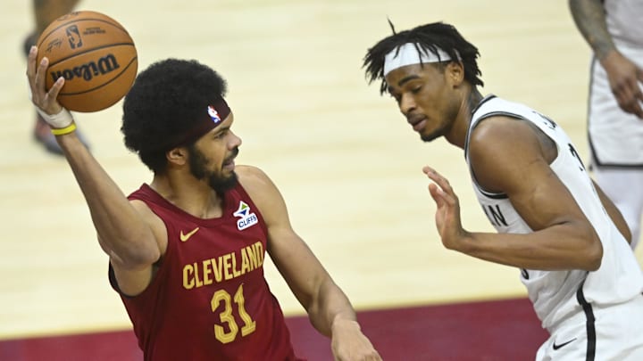 Mar 11, 2025; Cleveland, Ohio, USA; Cleveland Cavaliers center Jarrett Allen (31) throws a pass beside Brooklyn Nets center Nic Claxton (33) in the third quarter at Rocket Arena. Mandatory Credit: David Richard-Imagn Images