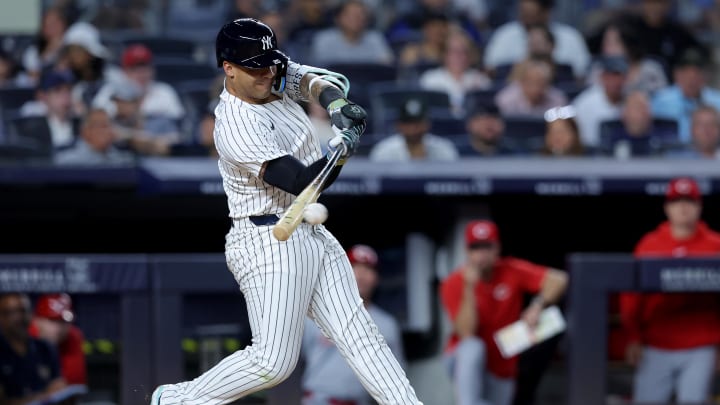 Jul 2, 2024; Bronx, New York, USA; New York Yankees second baseman Gleyber Torres (25) hits an RBI single against the Cincinnati Reds during the sixth inning at Yankee Stadium.