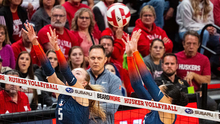 Oct 25, 2024; Lincoln, NE, USA; Illinois Fighting Illini outside hitter Taylor de Boer (5) and outside hitter Laynie Smith (23) go up for a block against the Nebraska Cornhuskers during the first set at Bob Devaney Sports Center. Mandatory Credit: Dylan Widger-Imagn Images