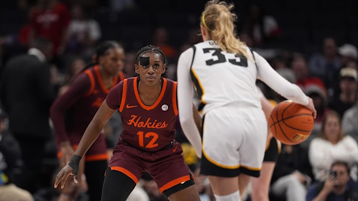 Nov 10, 2024; Charlotte, NC, USA; Virginia Tech Hokies guard Samyha Suffren (12) on defense against Iowa Hawkeyes guard Lucy Olsen (33) during the second half at Spectrum Center. Mandatory Credit: Jim Dedmon-Imagn Images