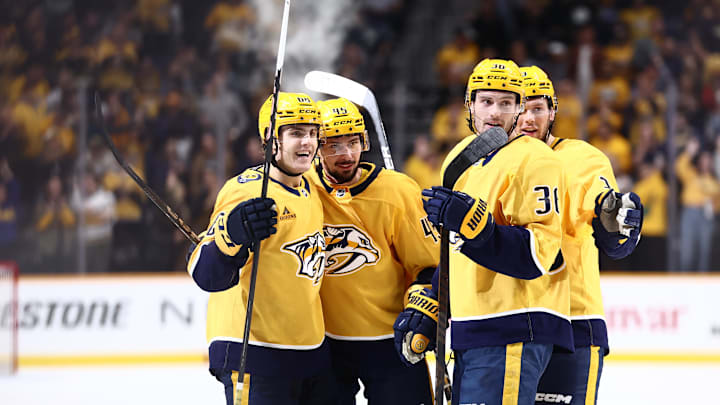 Oct 26, 2024; Nashville, Tennessee, USA; Nashville Predators celebrate with defenseman Alexandre Carrier (45) after a goal in the third period against the Columbus Blue Jackets at Bridgestone Arena. Mandatory Credit: Casey Gower-Imagn Images
