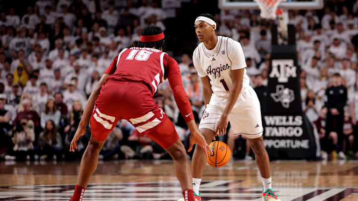 Jan 11, 2025; College Station, Texas, USA; Texas A&M Aggies guard Zhuric Phelps (1) handles the ball against Alabama Crimson Tide forward Jarin Stevenson (15) during the first half at Reed Arena. Mandatory Credit: Erik Williams-Imagn Images