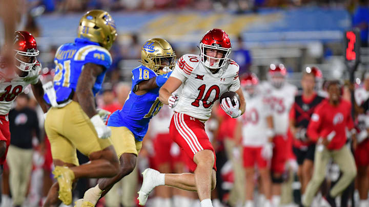Aug 30, 2025; Pasadena, California, USA; Utah Utes tight end Hunter Andrews (10) runs the ball against UCLA Bruins defensive back Jadyn Marshall (18) during the second half at Rose Bowl. Mandatory Credit: Gary A. Vasquez-Imagn Images