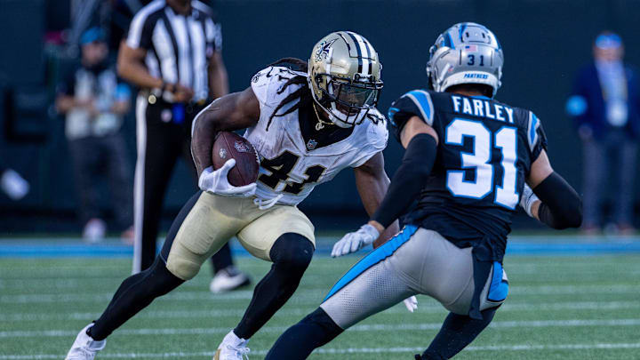 Nov 3, 2024; Charlotte, North Carolina, USA; New Orleans Saints running back Alvin Kamara (41) runs the ball against Carolina Panthers cornerback Caleb Farley (31) during the fourth quarter at Bank of America Stadium. Mandatory Credit: Scott Kinser-Imagn Images