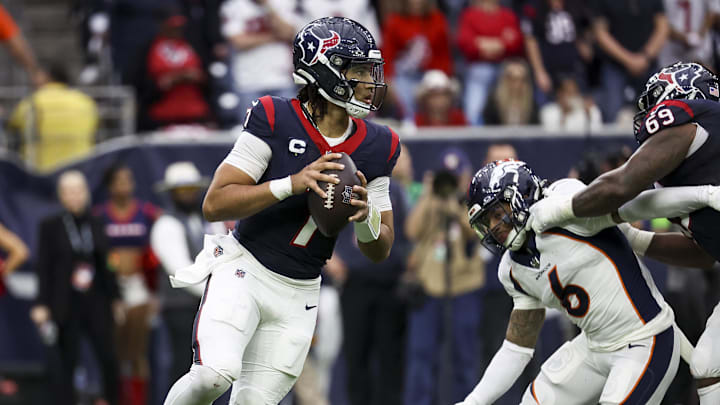 Dec 3, 2023; Houston, Texas, USA; Houston Texans quarterback C.J. Stroud (7) rolls out of the pocket on a play during the fourth quarter against the Denver Broncos at NRG Stadium. Mandatory Credit: Troy Taormina-Imagn Images