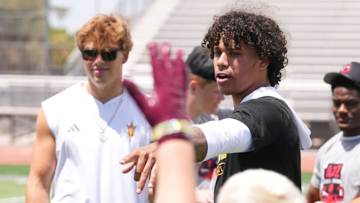 ASU quarterback Sam Leavitt and receiver Jordyn Tyson interact with children at a football camp sponsored by Pro Athletes Direct at Chandler High School on May 24, 2025, in Chandler.