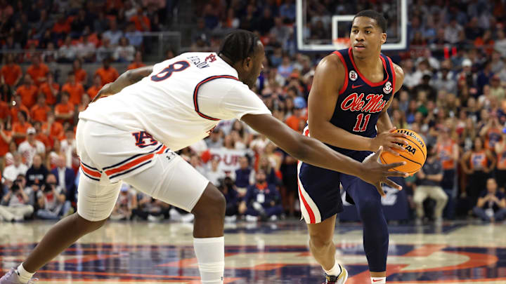 Feb 26, 2025; Auburn, Alabama, USA;  Mississippi Rebels guard Matthew Murrell (11) runs a play as Auburn Tigers forward Ja'Heim Hudson (8) closes in during the first half at Neville Arena. Mandatory Credit: John Reed-Imagn Images