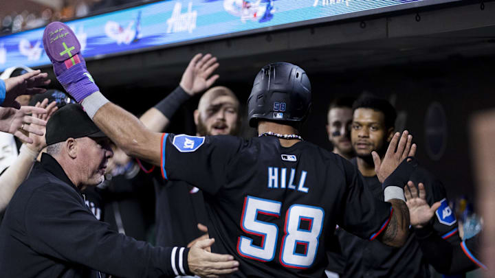 Aug 30, 2024; San Francisco, California, USA; Miami Marlins left fielder Derek Hill (58) is congratulated in the dugout after he scored against the San Francisco Giants during the seventh inning at Oracle Park. 