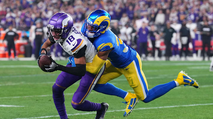 Jan 13, 2025; Glendale, AZ, USA; Minnesota Vikings wide receiver Justin Jefferson (18) makes a catch against Los Angeles Rams safety Quentin Lake (37) during the second half in an NFC wild card game at State Farm Stadium. Mandatory Credit: Joe Camporeale-Imagn Images Jan 13, 2025; Glendale, AZ, USA; Minnesota Vikings wide receiver Justin Jefferson (18) makes a catch against Los Angeles Rams safety Quentin Lake (37) during the second half in an NFC wild card game at State Farm Stadium. Mandatory Credit: Joe Camporeale-Imagn Images