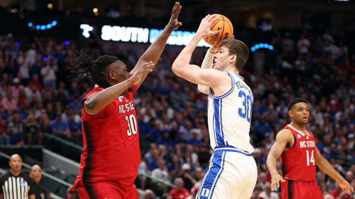 Mar 31, 2024; Dallas, TX, USA; Duke Blue Devils center Kyle Filipowski (30) shoots against North Carolina State Wolfpack forward DJ Burns Jr. (30) in the first half in the finals of the South Regional of the 2024 NCAA Tournament at American Airline Center. Mandatory Credit: Kevin Jairaj-USA TODAY Sports Mar 31, 2024; Dallas, TX, USA; Duke Blue Devils center Kyle Filipowski (30) shoots against North Carolina State Wolfpack forward DJ Burns Jr. (30) in the first half in the finals of the South Regional of the 2024 NCAA Tournament at American Airline Center. Mandatory Credit: Kevin Jairaj-USA TODAY Sports