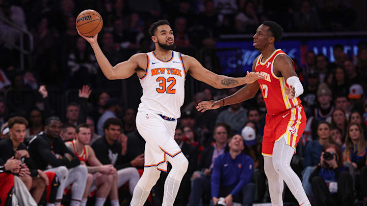Jan 20, 2025; New York, New York, USA; New York Knicks center Karl-Anthony Towns (32) looks to pass as Atlanta Hawks forward Onyeka Okongwu (17) defends during the second half at Madison Square Garden. Mandatory Credit: Vincent Carchietta-Imagn Images
