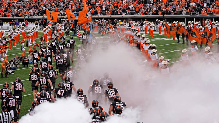 Oklahoma State players run on to the field before the first half the college football game between the Oklahoma State Cowboys and the Arizona State Sun Devils at Boone Pickens Stadium in Stillwater, Okla., Saturday, Nov., 2, 2024.