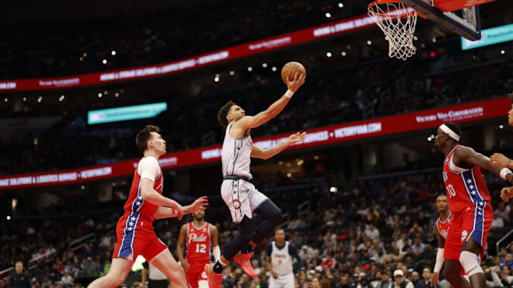 Apr 9, 2025; Washington, District of Columbia, USA; Washington Wizards guard Colby Jones (1) shoots the ball as Philadelphia 76ers center Colin Castleton (18) looks on in the second half at Capital One Arena. Mandatory Credit: Geoff Burke-Imagn Images