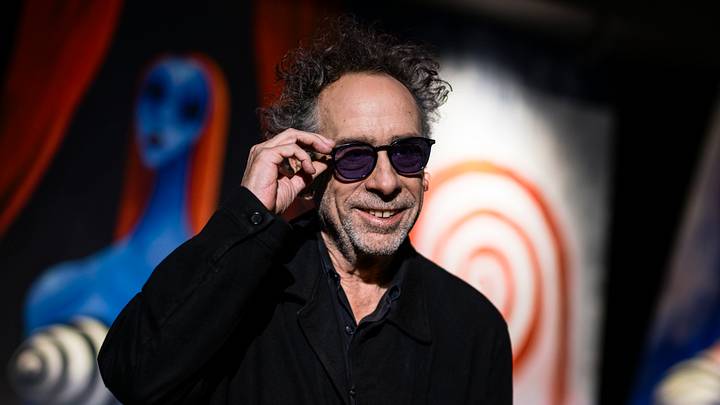 The American filmmaker Tim Burton smiles as he adjusts his glasses The American filmmaker Tim Burton smiles as he adjusts his glasses