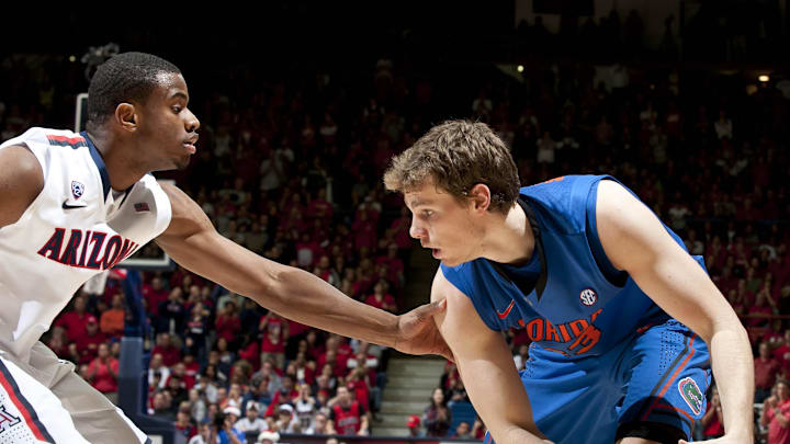 Dec 15, 2012; Tucson, AZ, USA; Florida Gators forward/center Erik Murphy (33) prepares to pass as Arizona Wildcats guard/forward Kevin Parrom (3) defends during the second half at McKale Center. The Wildcats beat the Gators 65-64.  Mandatory Credit: Casey Sapio-Imagn Images