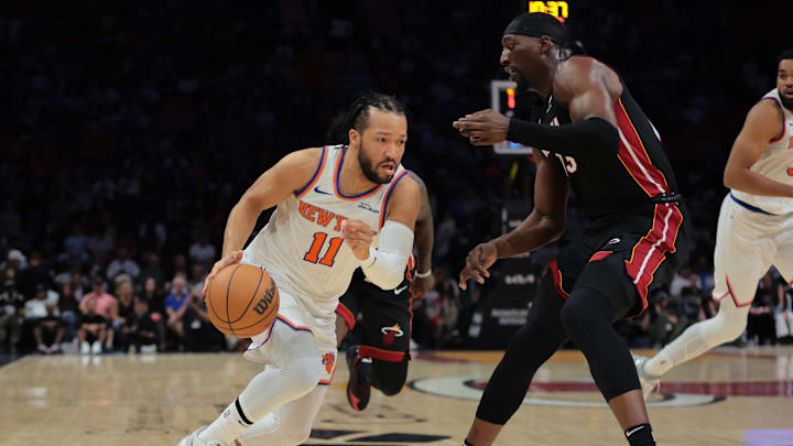 Mar 2, 2025; Miami, Florida, USA; New York Knicks guard Jalen Brunson (11) drives to the basket against Miami Heat center Bam Adebayo (13) during the first quarter at Kaseya Center. Mandatory Credit: Sam Navarro-Imagn Images