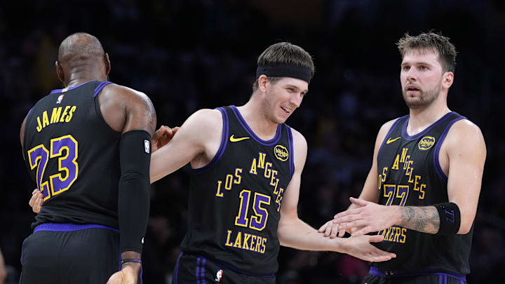 Nov 18, 2025; Los Angeles, California, USA; Los Angeles Lakers guard Austin Reaves (15) is congratulated by forward LeBron James (23) and guard Luka Doncic (77) after a three-point basket in the second quarter at Crypto.com Arena. Mandatory Credit: Kirby Lee-Imagn Images