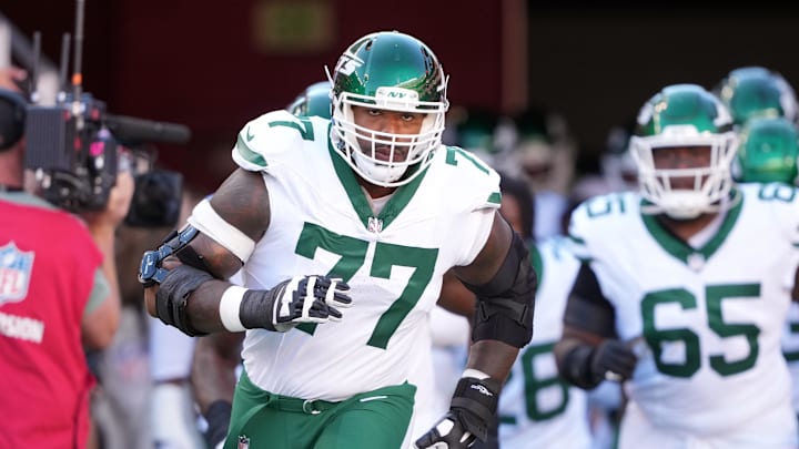 Sep 9, 2024; Santa Clara, California, USA; New York Jets offensive tackle Tyron Smith (77) jogs onto the field before the game against the San Francisco 49ers at Levi's Stadium. Mandatory Credit: Darren Yamashita-Imagn Images