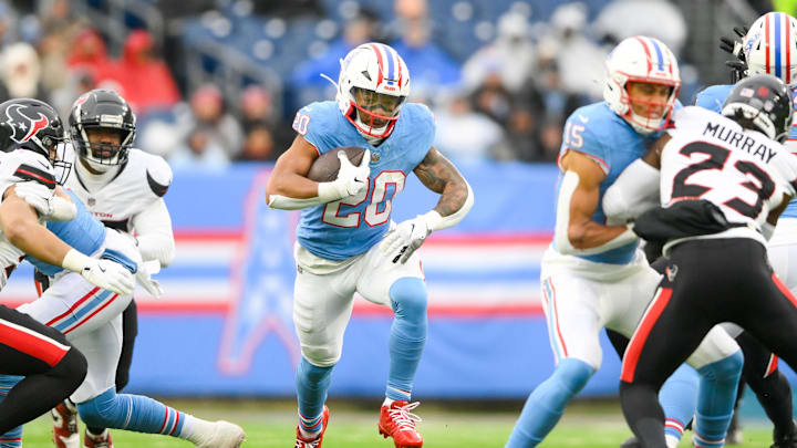 Jan 5, 2025; Nashville, Tennessee, USA;  Tennessee Titans running back Tony Pollard (20) runs the ball against the Houston Texans during the first half at Nissan Stadium. Mandatory Credit: Steve Roberts-Imagn Images