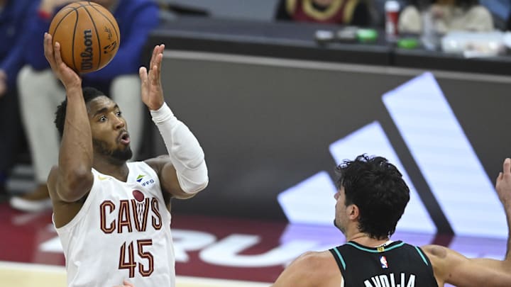 Dec 3, 2025; Cleveland, Ohio, USA; Cleveland Cavaliers guard Donovan Mitchell (45) shoots against Portland Trail Blazers forward Deni Avdija (8) in the fourth quarter at Rocket Arena. Mandatory Credit: David Richard-Imagn Images