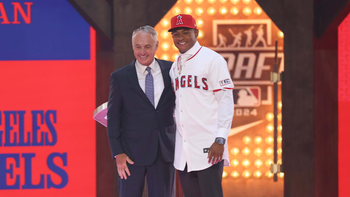 Jul 14, 2024; Ft. Worth, TX, USA; Christian Moore is congratulated by MLB commissioner Rob Manfred after being selected by the Los Angeles Angels as the eight player taken during the first round of the MLB Draft at Cowtown Coliseum. Mandatory Credit: Kevin Jairaj-Imagn Images Jul 14, 2024; Ft. Worth, TX, USA; Christian Moore is congratulated by MLB commissioner Rob Manfred after being selected by the Los Angeles Angels as the eight player taken during the first round of the MLB Draft at Cowtown Coliseum. Mandatory Credit: Kevin Jairaj-Imagn Images