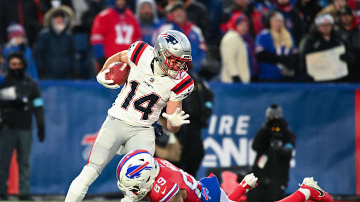 Dec 22, 2024; Orchard Park, New York, USA; New England Patriots wide receiver Alex Erickson (14) is tackled by Buffalo Bills wide receiver Jalen Virgil (89) on a kickoff return in the first quarter at Highmark Stadium. Mandatory Credit: Mark Konezny-Imagn Images