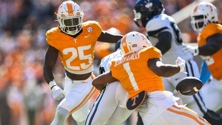 A UConn player drops the ball with Tennessee defensive back Jourdan Thomas (25) and Tennessee defensive back Gabe Jeudy-Lally (1) watches during the Tennessee football game against UConn at Neyland Stadium in Knoxville, Tenn., on Saturday, Nov. 4, 2023. A UConn player drops the ball with Tennessee defensive back Jourdan Thomas (25) and Tennessee defensive back Gabe Jeudy-Lally (1) watches during the Tennessee football game against UConn at Neyland Stadium in Knoxville, Tenn., on Saturday, Nov. 4, 2023.