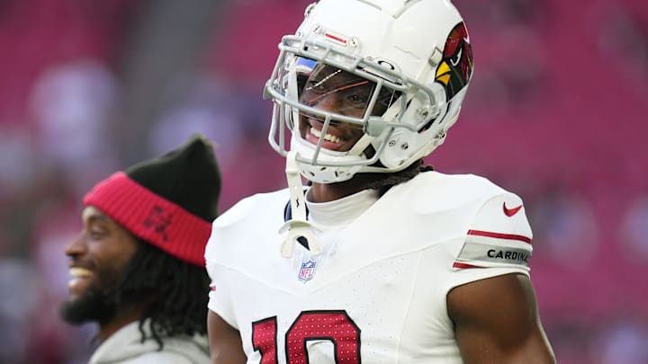 Arizona Cardinals receiver Marvin Harrison Jr. (18) smiles as the team takes the field to play the New England Patriots at State Farm Stadium on Dec. 15, 2024.