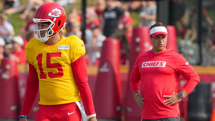 Jul 26, 2024; Kansas City, MO, USA; Kansas City Chiefs quarterback Patrick Mahomes (15) steps to the line as general manager Brett Veach watches in the background during training camp at Missouri Western State University. Mandatory Credit: Denny Medley-USA TODAY Sports