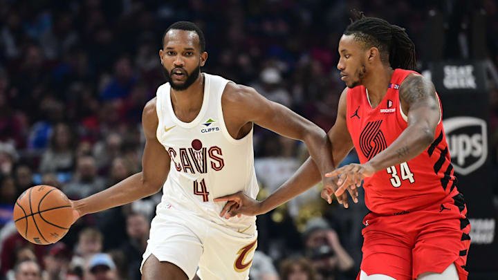 Mar 2, 2025; Cleveland, Ohio, USA; Cleveland Cavaliers forward Evan Mobley (4) brings the ball up court against Portland Trail Blazers forward Jabari Walker (34) during the first half at Rocket Arena. Mandatory Credit: Ken Blaze-Imagn Images