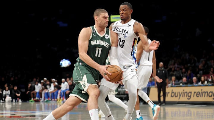 Feb 28, 2023; Brooklyn, New York, USA; Milwaukee Bucks center Brook Lopez (11) drives to the basket against Brooklyn Nets center Nic Claxton (33) during the third quarter at Barclays Center. Mandatory Credit: Brad Penner-Imagn Images