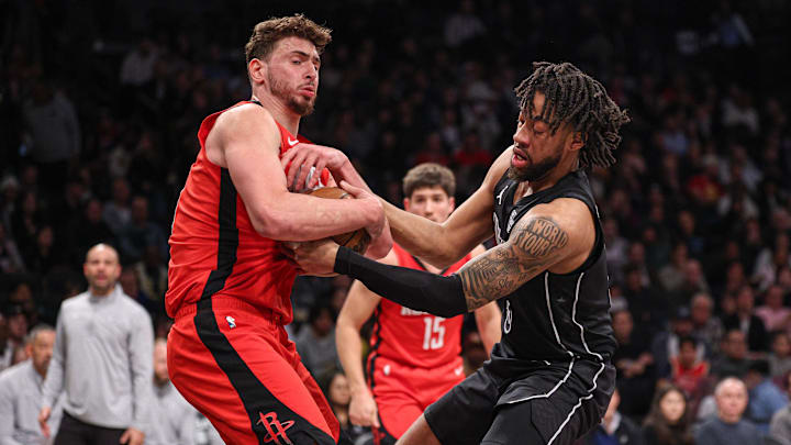 Feb 4, 2025; Brooklyn, New York, USA; Brooklyn Nets forward Trendon Watford (9) ties up with Houston Rockets center Alperen Sengun (28) during the second half at Barclays Center. Mandatory Credit: Vincent Carchietta-Imagn Images
