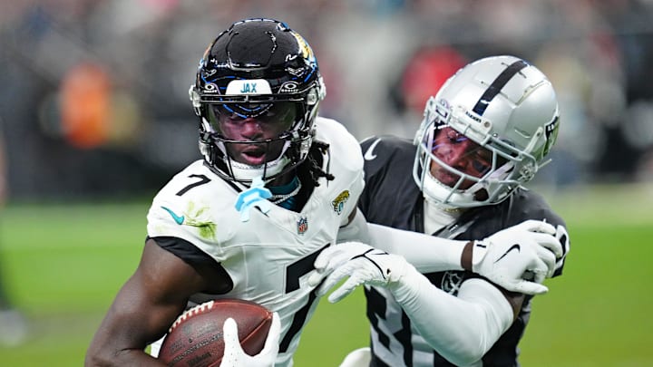 Dec 22, 2024; Paradise, Nevada, USA; Las Vegas Raiders cornerback Darnay Holmes (30) looks to knock the ball away from Jacksonville Jaguars wide receiver Brian Thomas Jr. (7) during the second quarter at Allegiant Stadium. Mandatory Credit: Stephen R. Sylvanie-Imagn Images