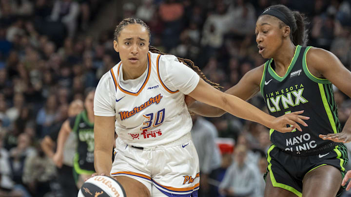 Jun 3, 2025; Minneapolis, Minnesota, USA; Phoenix Mercury guard Haley Jones (30) dribbles the ball as Minnesota Lynx forward Diamond Miller (1) plays defense in the second half at Target Center. Mandatory Credit: Jesse Johnson-Imagn Images